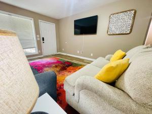 a living room with a couch and a tv at Eastgate 18A beautiful townhouse in Hammond