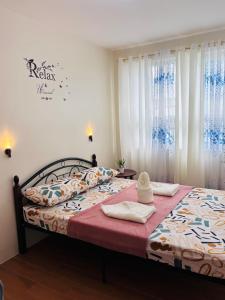 a bedroom with a bed with two towels on it at Seawind Condominium in Davao City +17 photos