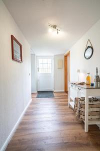 an empty room with a table and a door at Ostseeurlaub mit Parkblick und Sauna in Rabenholz +20 photos