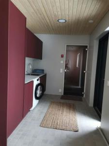 a bathroom with a sink and a washing machine at Spacious Apartment for 8 with Sauna in Syöte +6 photos