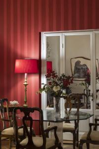 a dining room with a table with a vase of flowers at Palace Hotel in Viareggio