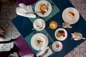 a table with plates of food and a cup of coffee at Palace Hotel in Viareggio