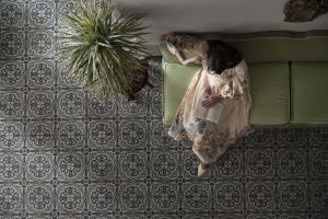 a woman in a dress sitting on a couch at Palace Hotel in Viareggio
