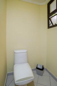a white toilet in a room with a window at Suíte privativa 5 minutos metrô com Piscina e churrasqueira in Sao Paulo