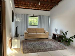 a living room with a couch and a television at Casa aconchegante in Barra de Santo Antônio