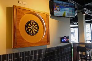 a dart board on the wall of a restaurant at SOPO Backpackers in Gold Coast