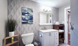 a bathroom with a white toilet and a sink at Private Atlanta Tiny House with Mini Golf in Forest Park