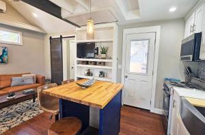 a kitchen and living room with a wooden counter top at Private Atlanta Tiny House with Mini Golf in Forest Park