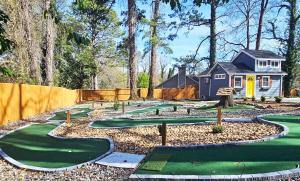 a yard golf course with a house in the background at Private Atlanta Tiny House with Mini Golf in Forest Park +10 photos