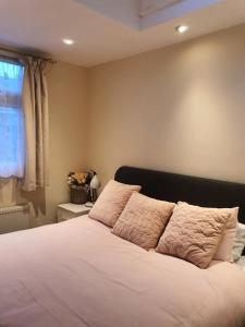 a bedroom with a bed with white sheets and a window at Animal friendly Sea 2 mins away in Trusthorpe