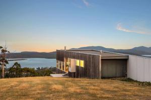 a house on top of a hill with a view at Marion Bay House, Luxury Retreat in Bream Creek