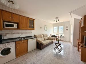 a kitchen and living room with a couch and a table at La Cava en Isla - 5611 in Isla