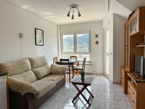 a living room with a couch and a table at La Cava en Isla - 5611 in Isla