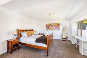a bedroom with a bed and a desk at Stylish Studio with Stunning Views in Lindisfarne