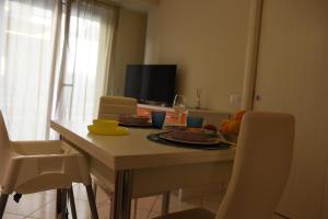 a dining room table with plates of food on it at casa vacanze La Farfalla in Capo dʼOrlando +9 photos