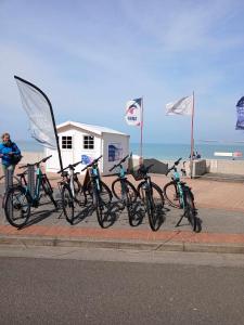 a group of bikes parked next to the beach at Face à la mer by Corinne in Mers-les-Bains +27 photos