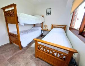 a bedroom with two bunk beds and a ladder at Calmarena in Mar del Plata