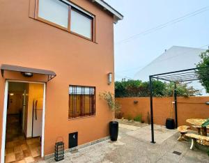 a house with an open door and a patio at Calmarena in Mar del Plata