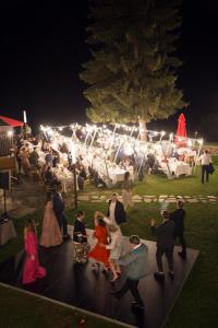 a group of people dancing at a party at night at Хотел Гела in Gela