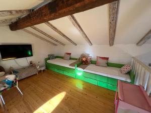 an attic room with two beds and a flat screen tv at Villa Rafaela Umag in Umag