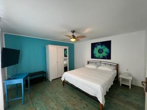 a bedroom with a white bed and a blue wall at Villa Rafaela Umag in Umag +20 photos