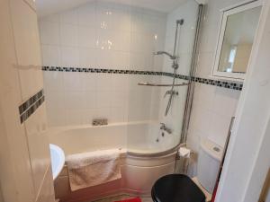 a bathroom with a tub and a toilet and a sink at Violey Cottage in Maryport +24 photos