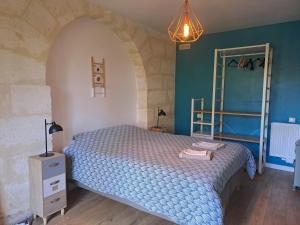 a bedroom with a bed with a blue comforter at Domaine Ecoline in Sadirac +65 photos