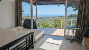 a bedroom with a bed and a balcony with a view at Cabañas Laguna Bella - Bella in San Carlos +11 photos