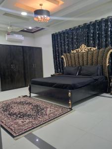 a bedroom with a bed and a couch and a rug at Haris villa in Dargai