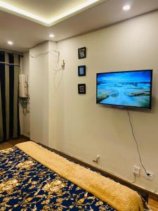 a living room with a flat screen tv on a wall at Haris villa in Dargai