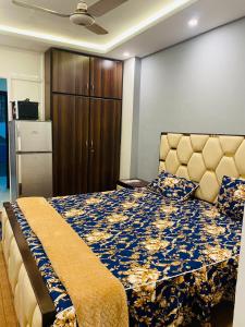 a bedroom with a bed with a blue and gold bedspread at Haris villa in Dargai