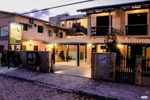 an empty street in front of a building at night at Pousada Carolina Apartamentos in Penha