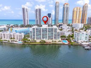 a red marker on top of a building near the water at Bay View Oasis with Balcony & Free Parking Sunny Isles Beach in Sunny Isles Beach