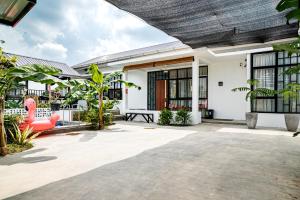 a courtyard of a house with plants and a patio at Villa RNB 2BR Medan in Sunggal