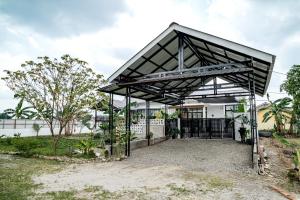 a metal pavilion in front of a building at Villa RNB 2BR Medan in Sunggal