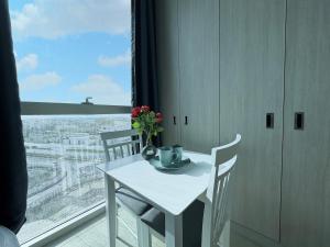un tavolo bianco e sedie in una stanza con una finestra di Luxury Private Apartment-BEST PRICE a Abu Dhabi Altre 8 foto