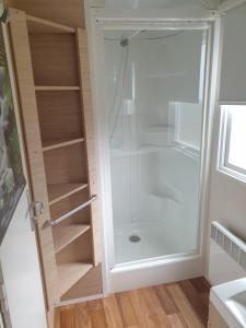 a shower with a glass door in a bathroom at Camping Pré Vologne in Granges-sur-Vologne