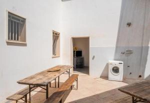 a room with a wooden table and a washing machine at Chill e Relax Sul Mare in Sant'Isidoro
