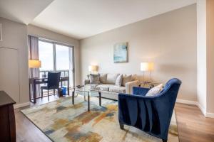 a living room with a couch and a table at Gorgeous Apt w Harbor Views & Gym in South End