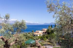 a house on a hill with the ocean in the background at Ionian Sea in Nikiana