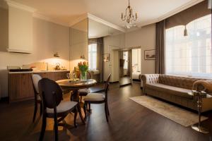 a living room with a couch and a table at Piotrkowska 89 Residence in Łódź