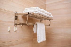 a towel rack in a bathroom with towels at Akwaaba Fie in Accra