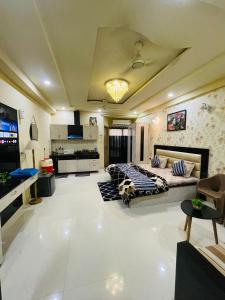 a large living room with a bed and a kitchen at NAMAH RESORT HOMESTAY with KITCHEN Near PREM MANDIR in Vrindāvan