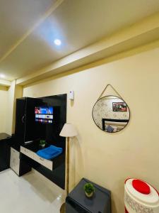 a living room with a mirror on the wall at NAMAH RESORT HOMESTAY with KITCHEN Near PREM MANDIR in Vrindāvan