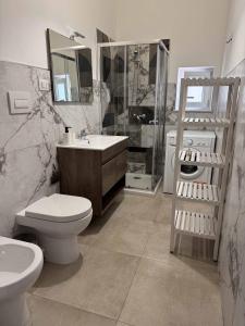 a bathroom with a toilet and a sink and a shower at Living Room Orlando in Corigliano Calabro +23 photos