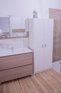 a white bathroom with a sink and a shower at Modern House Monolocali in Le Castella +36 photos