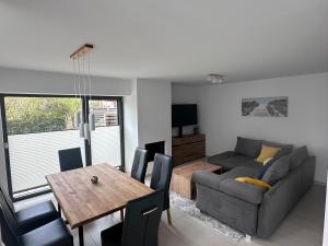 a living room with a couch and a dining room table at Meerblick-Residence-Appartement 6 in Breege