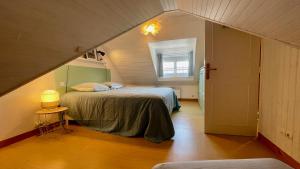 a bedroom with a bed and a window in a attic at TI Soul - Calme- Authentique in Crozon