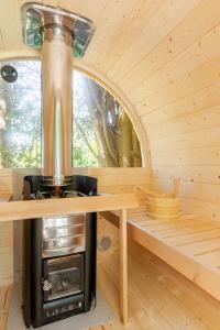 a stove in a sauna with a window at Tinyhouse et abeilles, séjour insolite en Provence in Orange