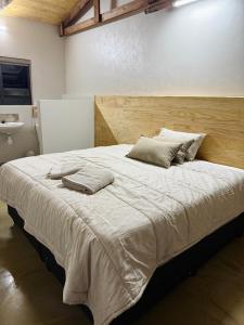 a large bed in a room with a sink at The Mills in Warden